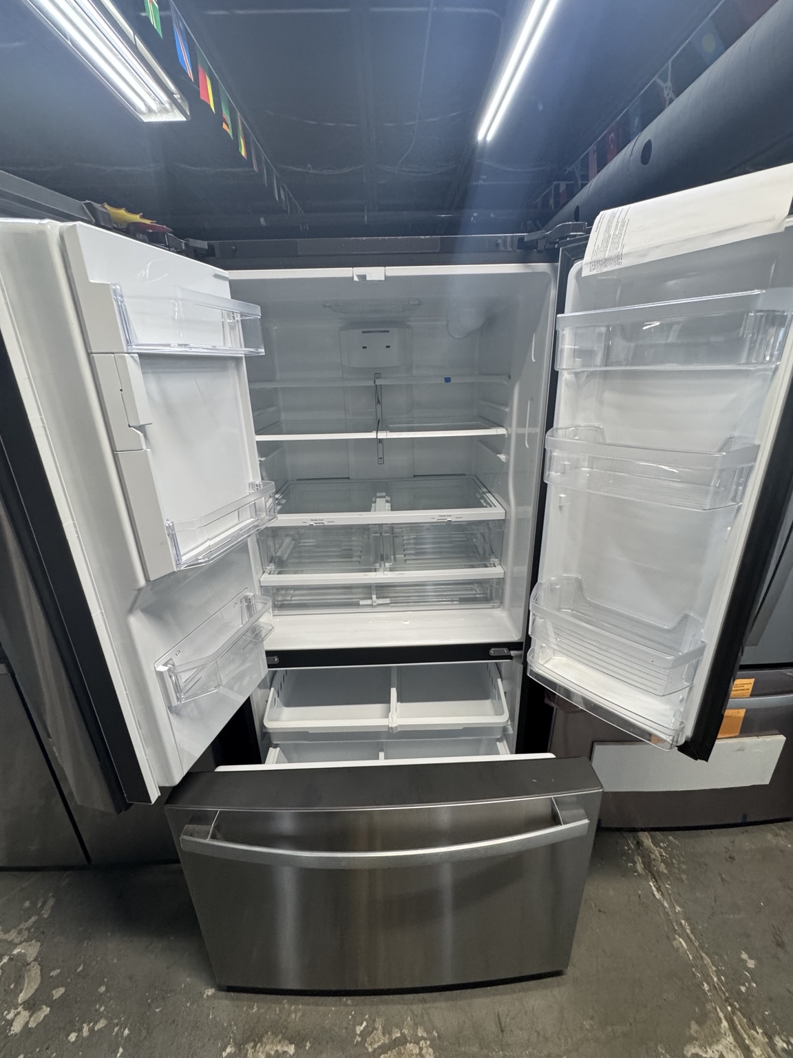 Clean interior of GE GFE26JYMFS French-door refrigerator