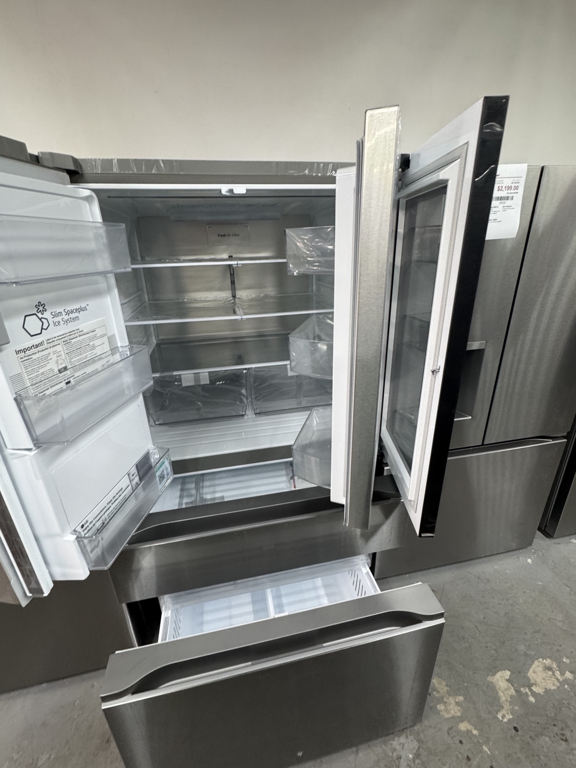 Interior of LG LH29S8565S refrigerator with doors and convertible drawer open