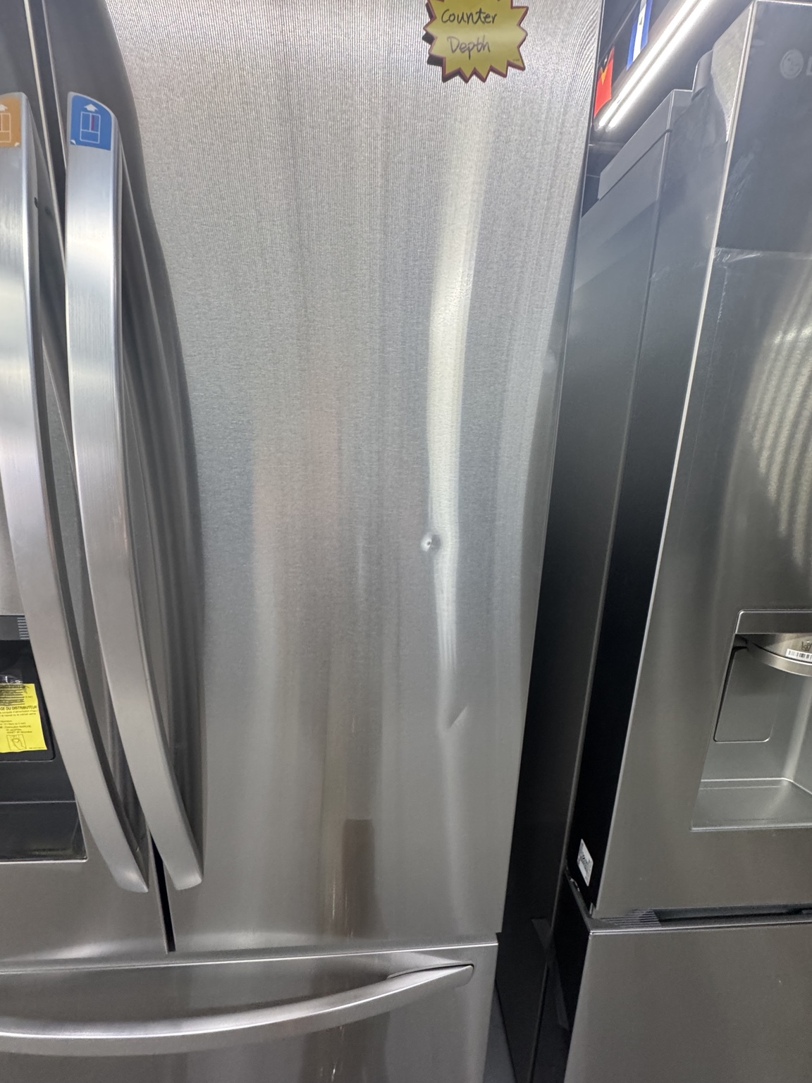 Small cosmetic dent on the right refrigerator door