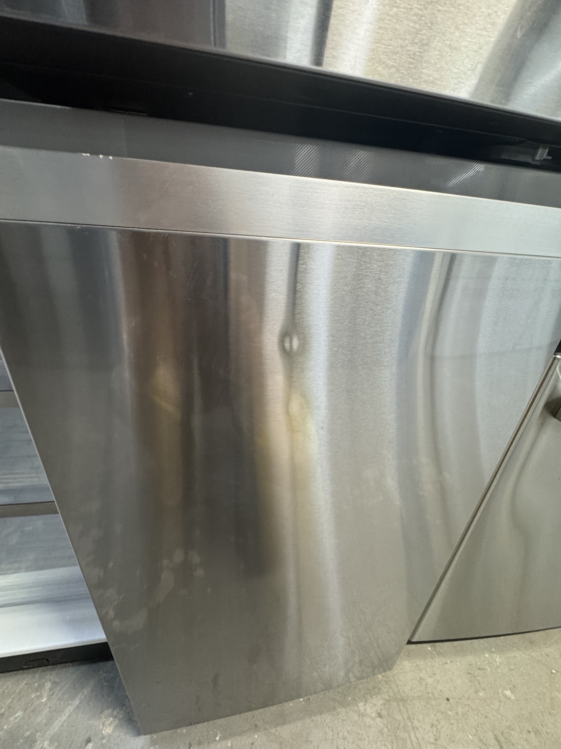 Small cosmetic dent on lower right refrigerator door