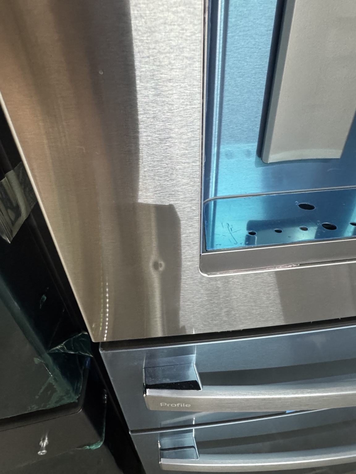 Small cosmetic dent near the refrigerator dispenser