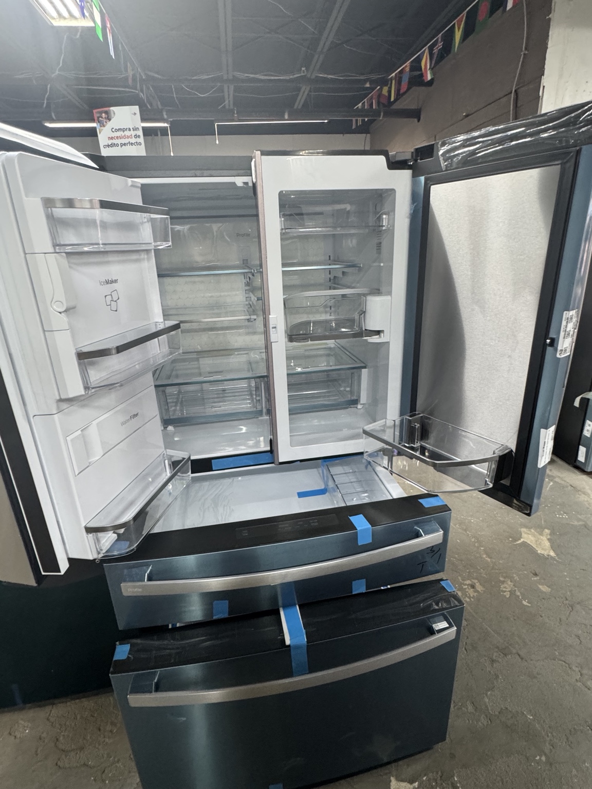 Interior of GE Profile PVD28BYNFS refrigerator with doors and drawers open