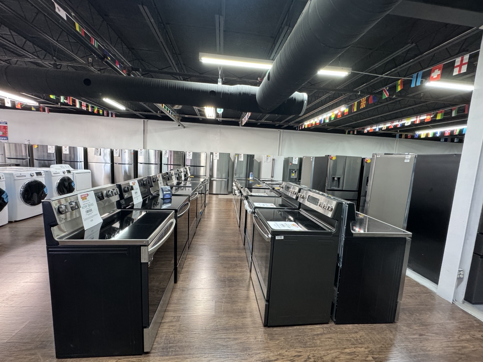 Wide view of ranges and refrigerators in the Bradenton appliance showroom