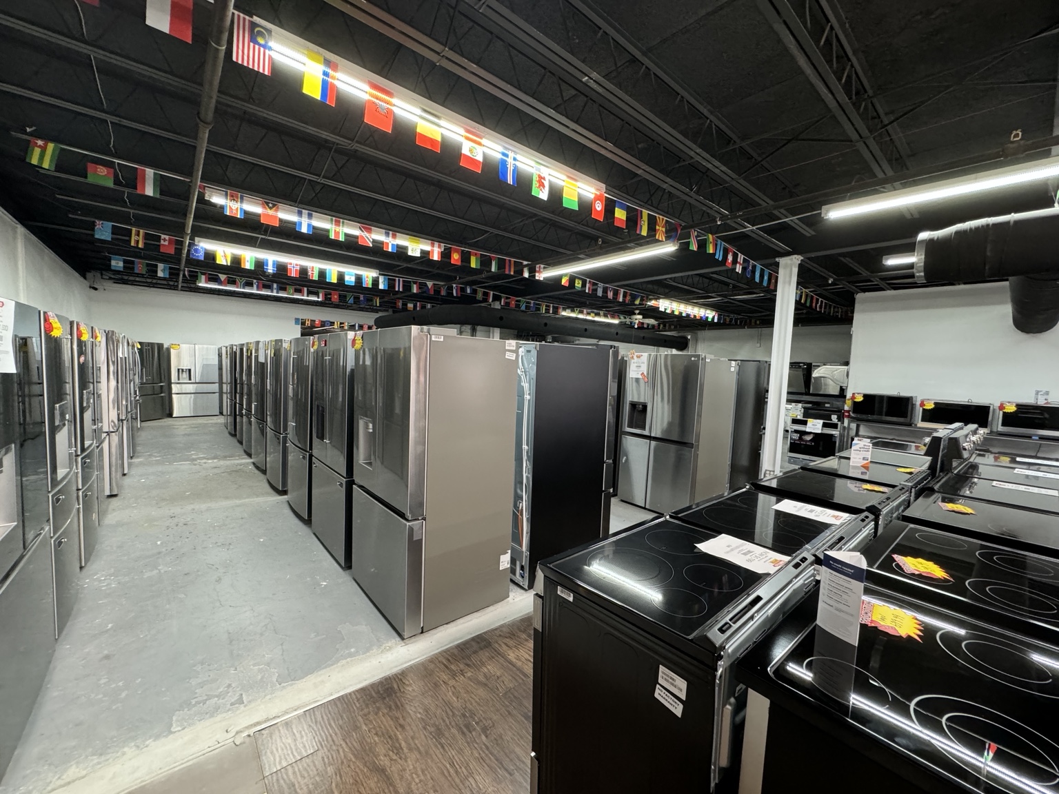 Appliances 4 Less Bradenton showroom with rows of refrigerators and ranges